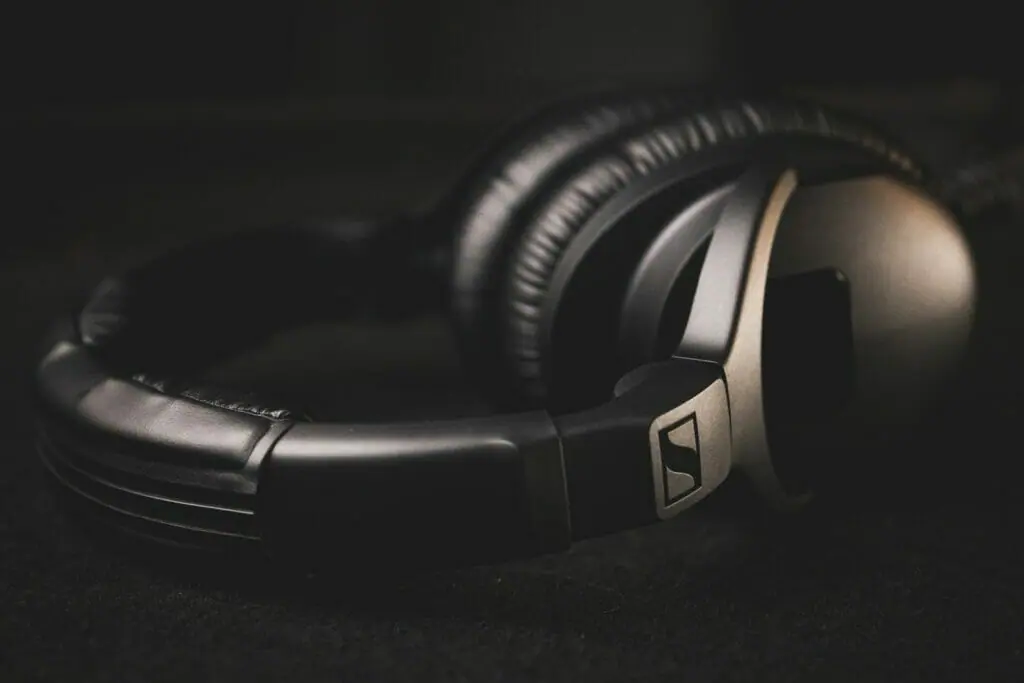 black and silver headphones on black textile