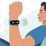 A person sitting calmly with eyes closed, wearing a fitness tracker on their wrist showing a breathing animation.