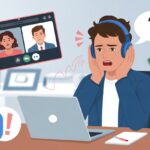 A person at a desk wearing Bluetooth headphones looking confused while using a laptop for a video call.