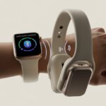 Close-up of an Apple Watch on a wrist next to a pair of Bluetooth headphones with visual indicators showing they are connecting wirelessly.