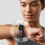 A person wearing a fitness tracker on their wrist with notification icons appearing around it.