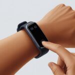 Why is my fitness tracker not responding to button presses? When Your Step Counter Pretends It’s a Brick Close-up of a fitness tracker on a wrist with a finger pressing a button but the screen is blank and unresponsive.