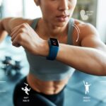 A person doing a high-intensity workout wearing a fitness tracker on their wrist in a gym setting.