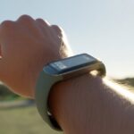 Why is my fitness tracker not displaying correctly in sunlight? How Your Watch Became a Vampire A close-up of a wrist wearing a fitness tracker outdoors in bright sunlight, showing the screen partially washed out by glare.