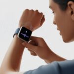 How to use a smartwatch with Google Assistant and Finally Feel Like a Secret Agent A person speaking to a smartwatch on their wrist, with icons indicating voice command and digital assistant functionality.