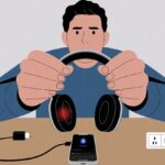 A person sitting at a desk looking confused while holding Bluetooth headphones with a red light, next to a smartphone showing disconnected Bluetooth settings.