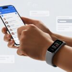 How to use a fitness tracker for Facebook Messenger: Counting Steps, Not Just Emojis A close-up of a person’s hand wearing a fitness tracker while using a smartphone with the Facebook Messenger app open.