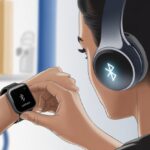 How to Pair Bluetooth Headphones with a Garmin Watch Without Losing Your Cool A person holding a Garmin smartwatch showing a Bluetooth icon near a pair of Bluetooth headphones, illustrating the pairing process.