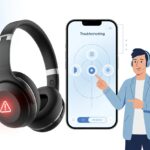A pair of Bluetooth headphones with a red warning icon, a smartphone showing troubleshooting icons, and a technician pointing at them to indicate fixing an error.