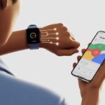 A person syncing a smartwatch with a smartphone showing health activity rings on the screen.