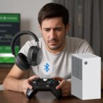 Why do my Bluetooth headphones not connect to Xbox? The Mystery of Wireless Betrayal A person sitting in front of an Xbox console holding Bluetooth headphones, looking confused about connecting them.