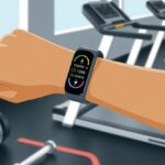 How to use a fitness tracker for calorie tracking and finally prove you didn’t just burn off one potato chip A close-up of a person wearing a fitness tracker on their wrist showing calorie tracking data with gym equipment blurred in the background.