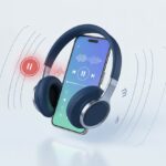 Why do my Bluetooth headphones not pause music? Your Playlist’s Evil Plan Revealed A pair of Bluetooth headphones floating near a smartphone showing a music player with the pause button inactive and wireless signals around them.